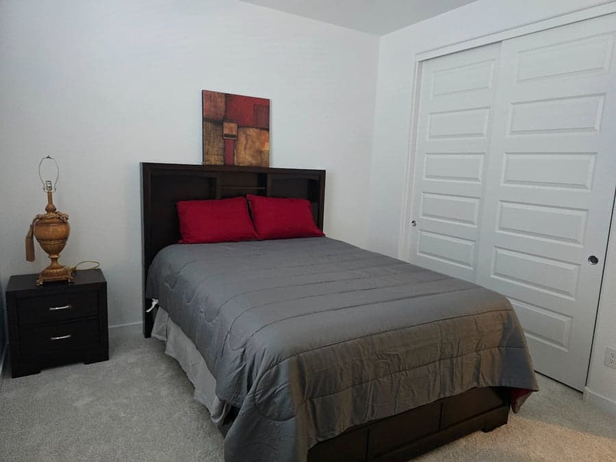 Guest bedroom with queen bed and nightstand